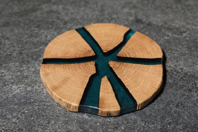 Photo of Stylish wooden cup coaster on grey table, closeup
