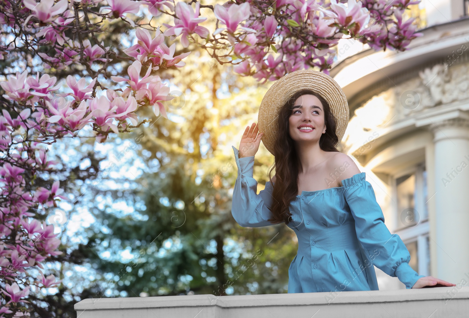 Photo of Beautiful woman near blossoming magnolia tree on spring day