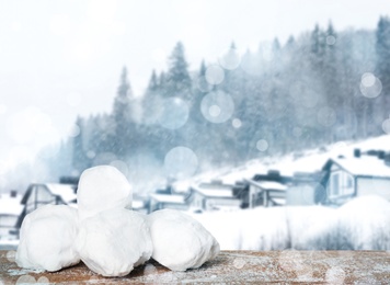 Image of Snowballs against blurred mountain forest. Winter outdoor activity