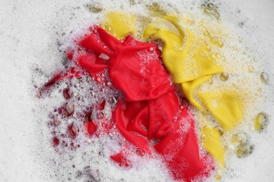 Photo of Color clothing in suds, top view. Hand washing laundry