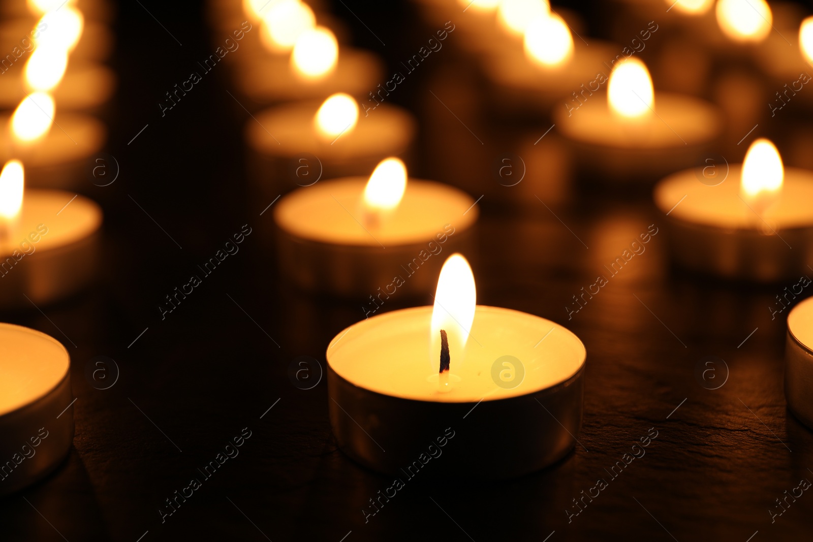 Photo of Many burning candles on table. Memory day