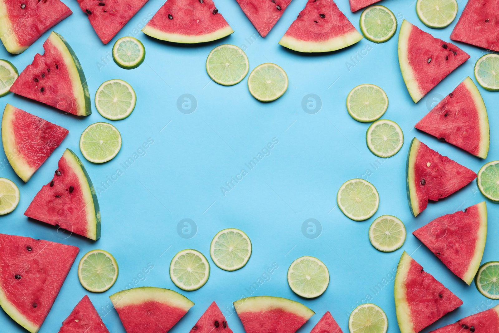 Photo of Frame of tasty sliced watermelon and limes on light blue background, flat lay. Space for text