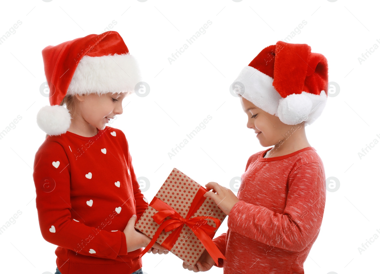 Photo of Cute little children wearing Santa hats with Christmas gift on white background