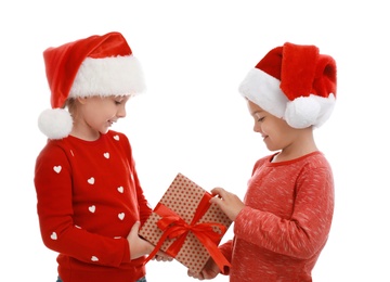 Photo of Cute little children wearing Santa hats with Christmas gift on white background