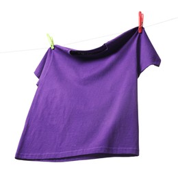 Photo of One purple t-shirt drying on washing line isolated on white, low angle view