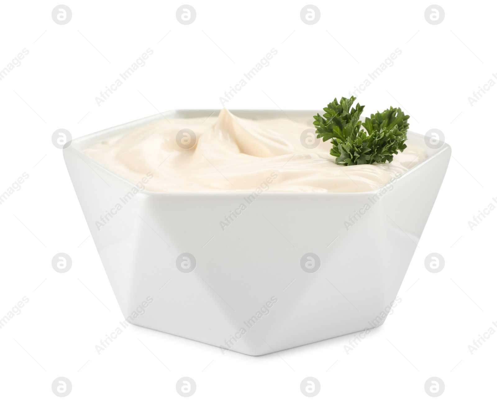 Photo of Bowl of tasty mayonnaise with parsley isolated on white