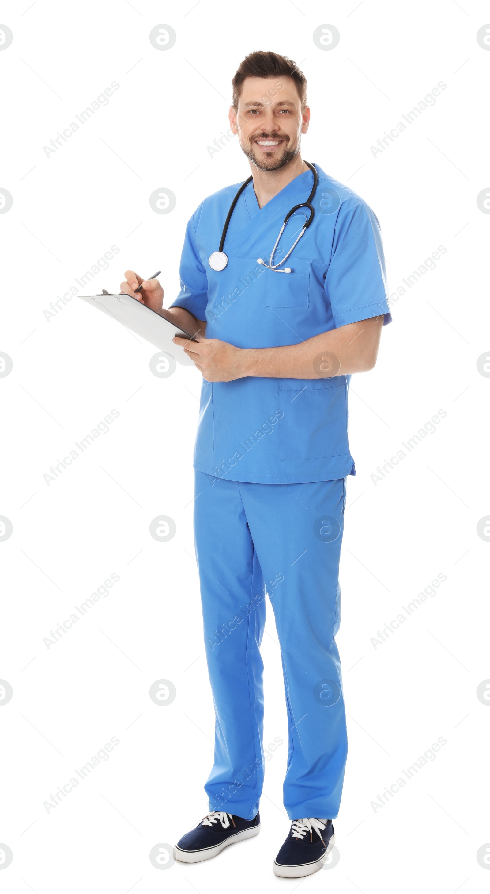 Photo of Full length portrait of smiling male doctor in scrubs with clipboard isolated on white. Medical staff