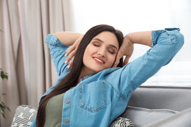 Young woman relaxing on couch at home