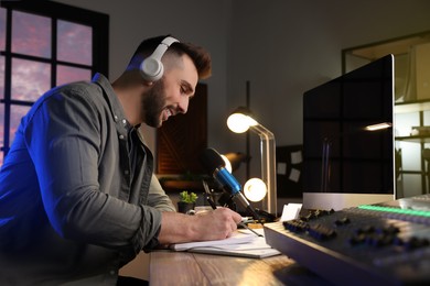 Photo of Man working as radio host in modern studio