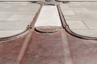 Street tiles with metal ground surface indicators, closeup