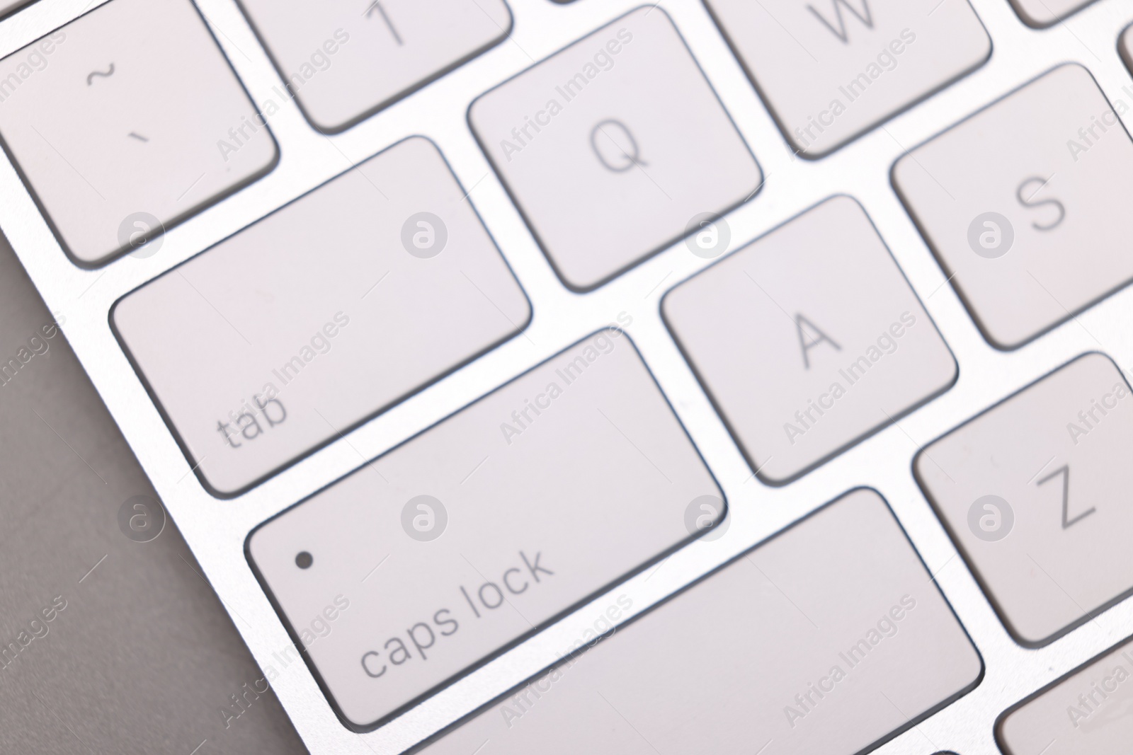 Photo of Internet shopping. Computer keyboard on grey background, top view