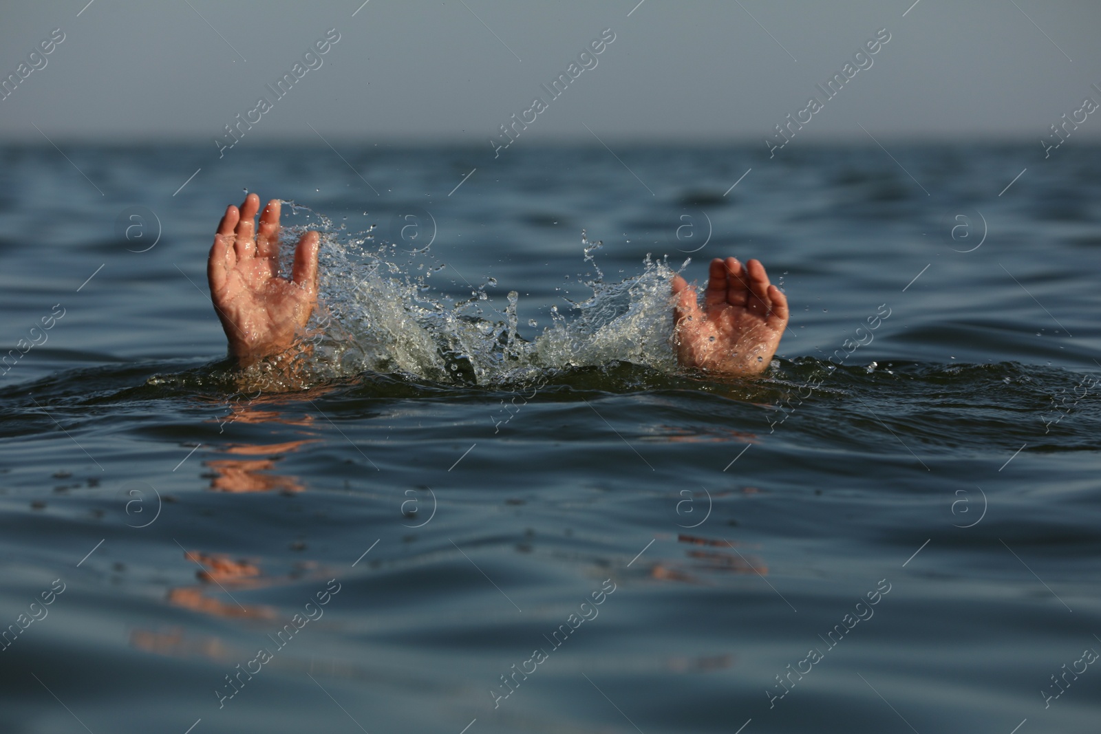 Photo of Drowning man reaching for help in sea