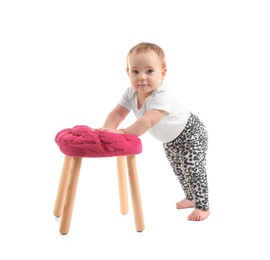 Cute baby holding on to stool on white background. Learning to walk