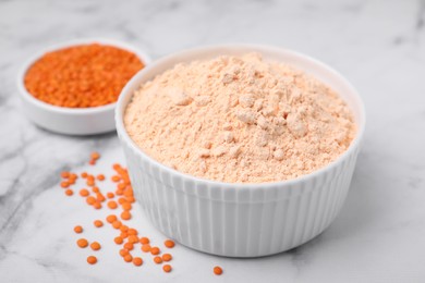 Photo of Lentil flour and seeds on white marble table, closeup