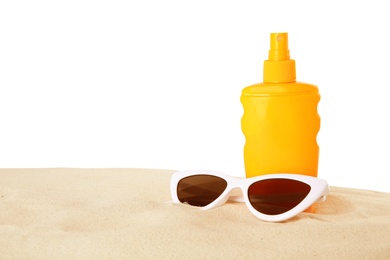 Bottle of sun protection body cream and glasses on white background