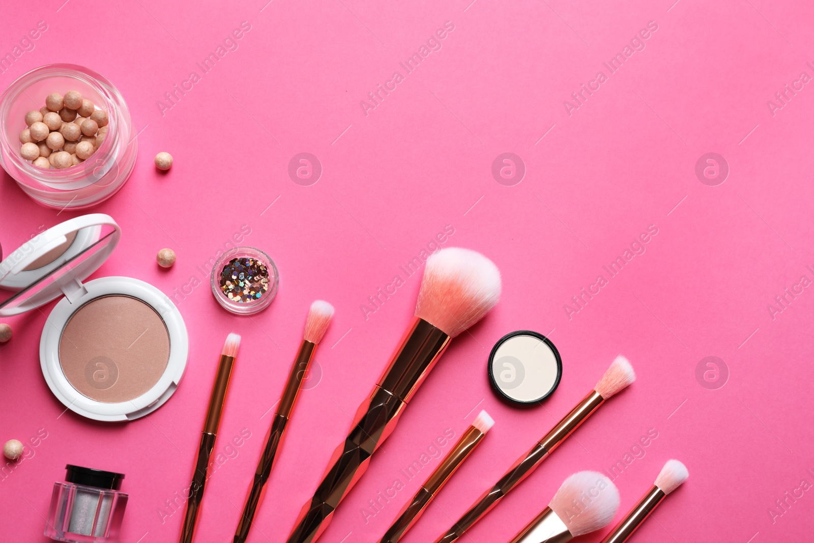Photo of Flat lay composition with makeup brushes on pink background. Space for text