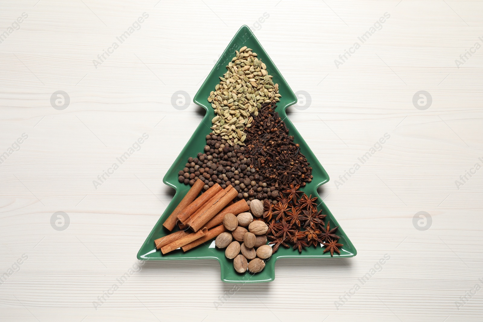 Photo of Different spices and nuts on white wooden table, top view