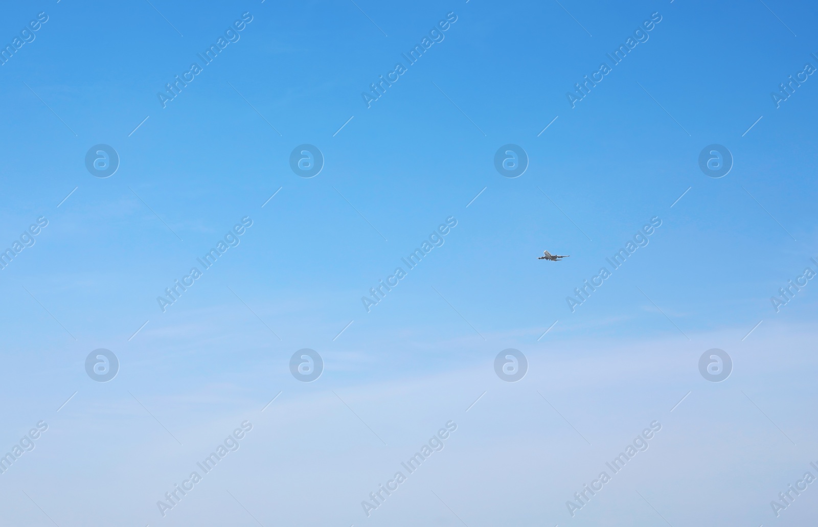 Photo of Distant view of modern airplane in blue sky