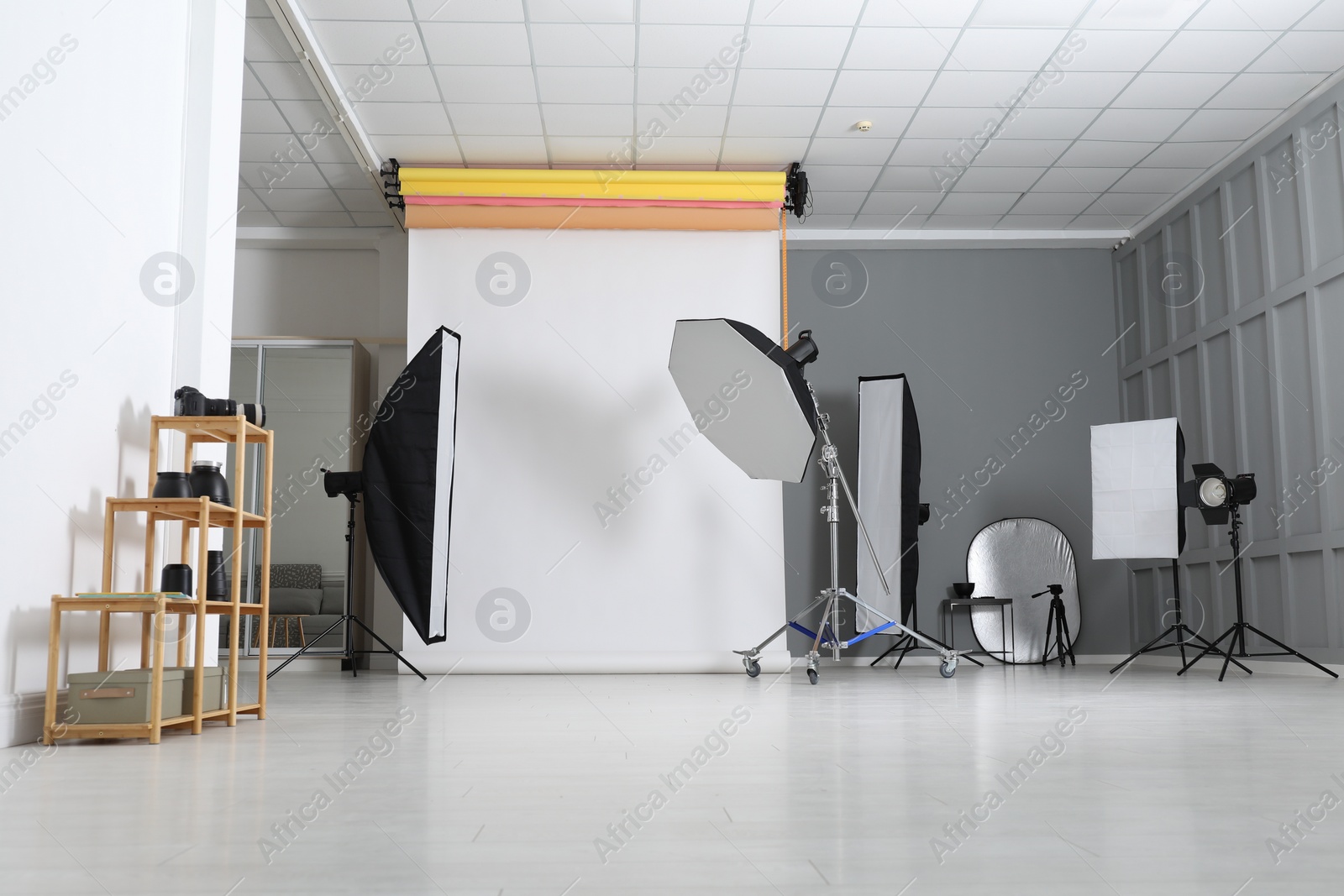 Photo of White photo background and professional lighting equipment in studio