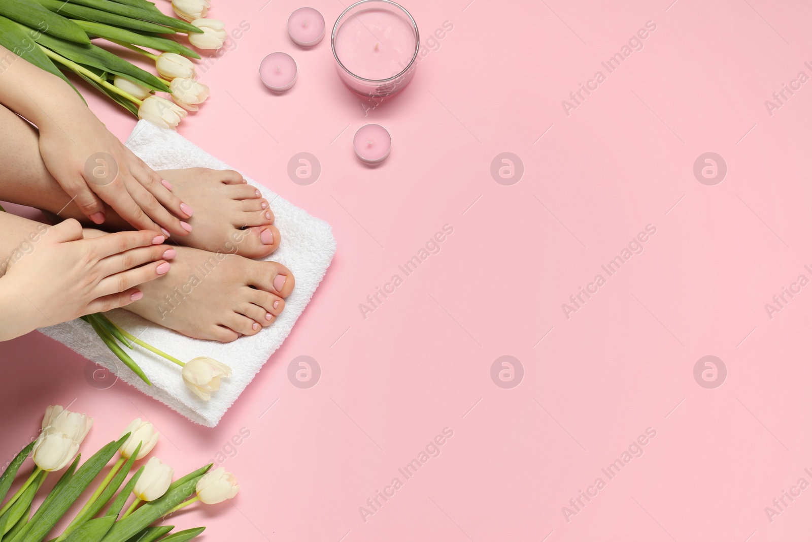 Photo of Closeup of woman with neat toenails after pedicure procedure on pink background, top view. Space for text