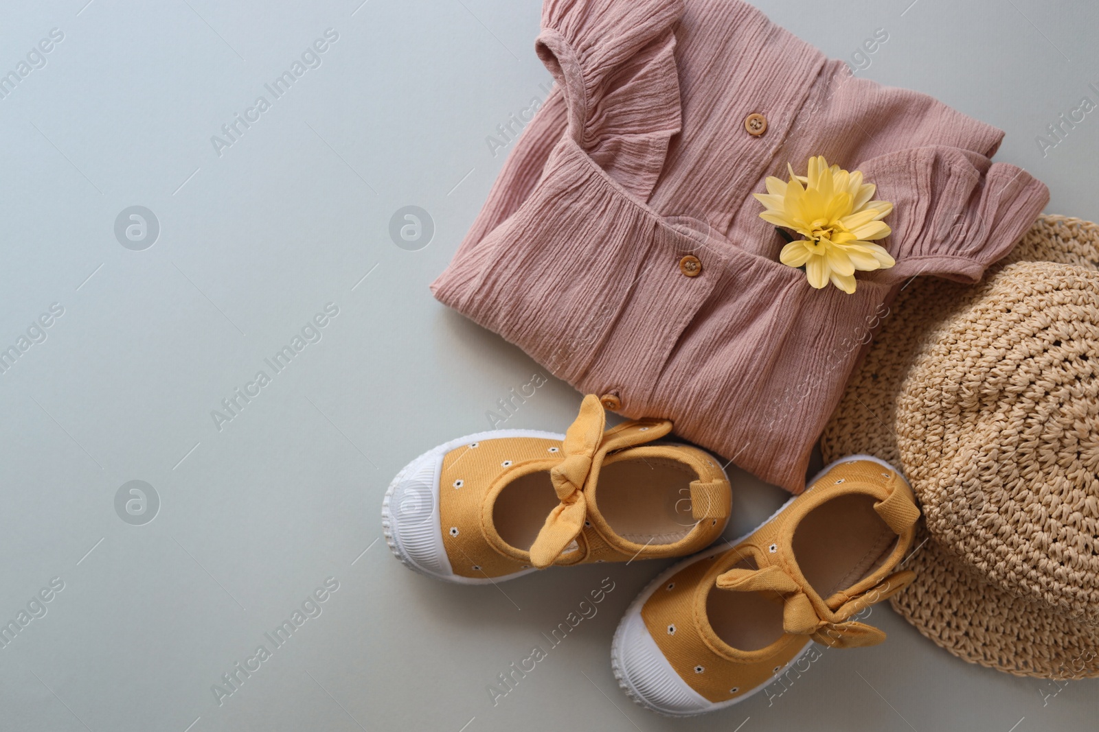 Photo of Stylish child clothes, shoes and hat on grey background, flat lay. Space for text