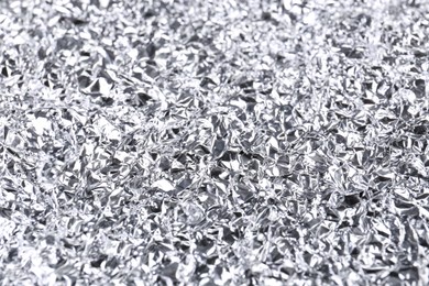 Photo of Crumpled silver foil as background, closeup view