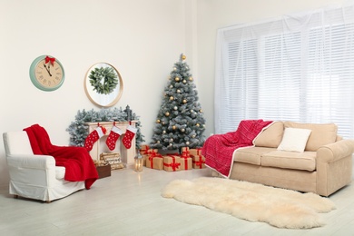 Stylish Christmas interior with decorated fir tree and fireplace