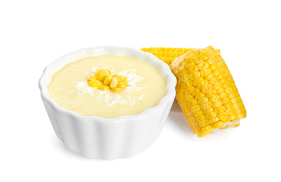 Photo of Delicious corn cream soup and cobs on white background