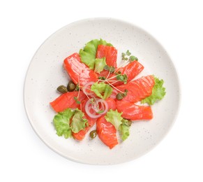 Photo of Salmon carpaccio with capers, lettuce, microgreens and onion isolated on white, top view