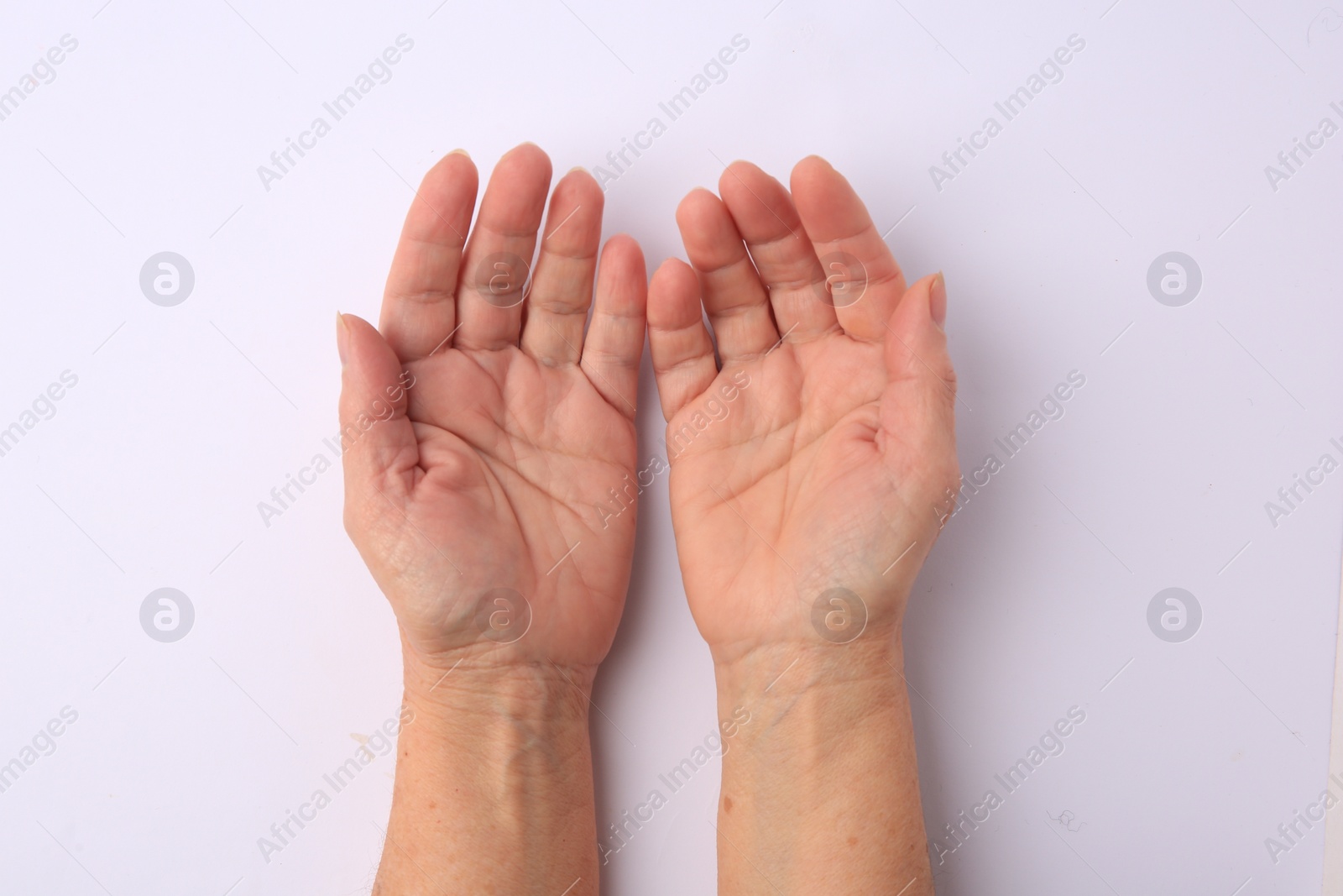 Photo of Closeup view of woman's hands with aging skin, top view