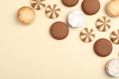 Photo of Delicious cookies on beige background, flat lay. Space for text