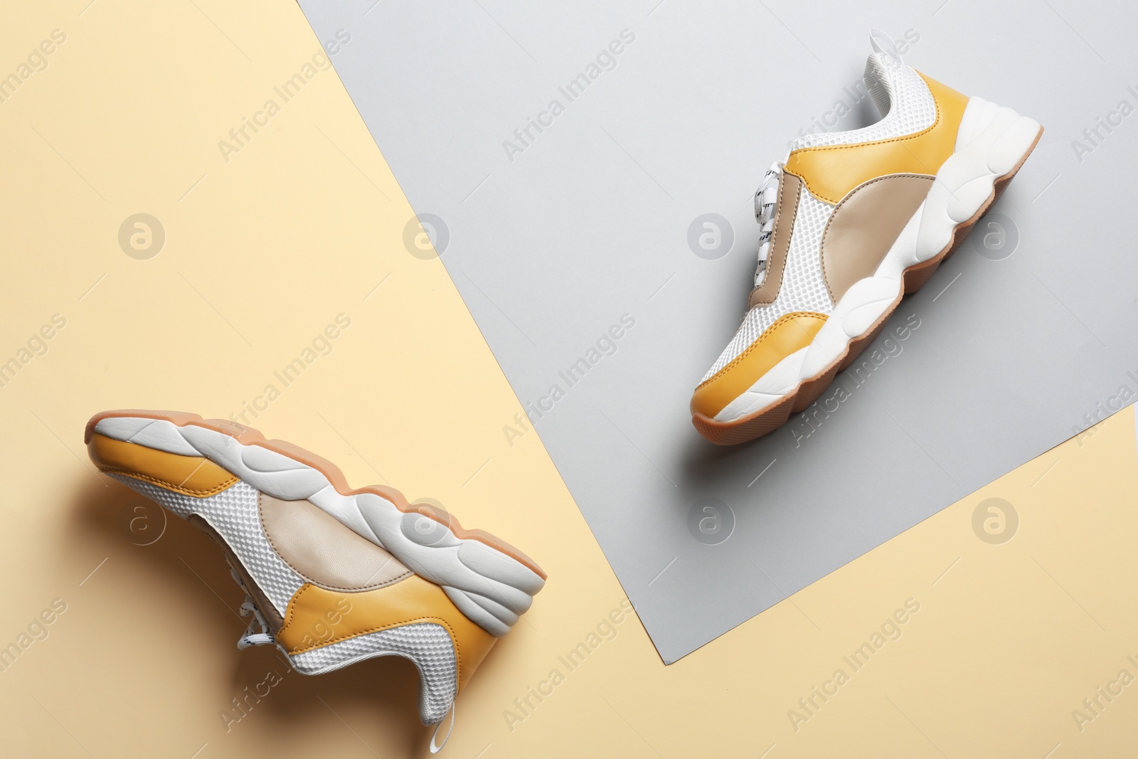 Photo of Pair of sports shoes on color background, top view. Space for text