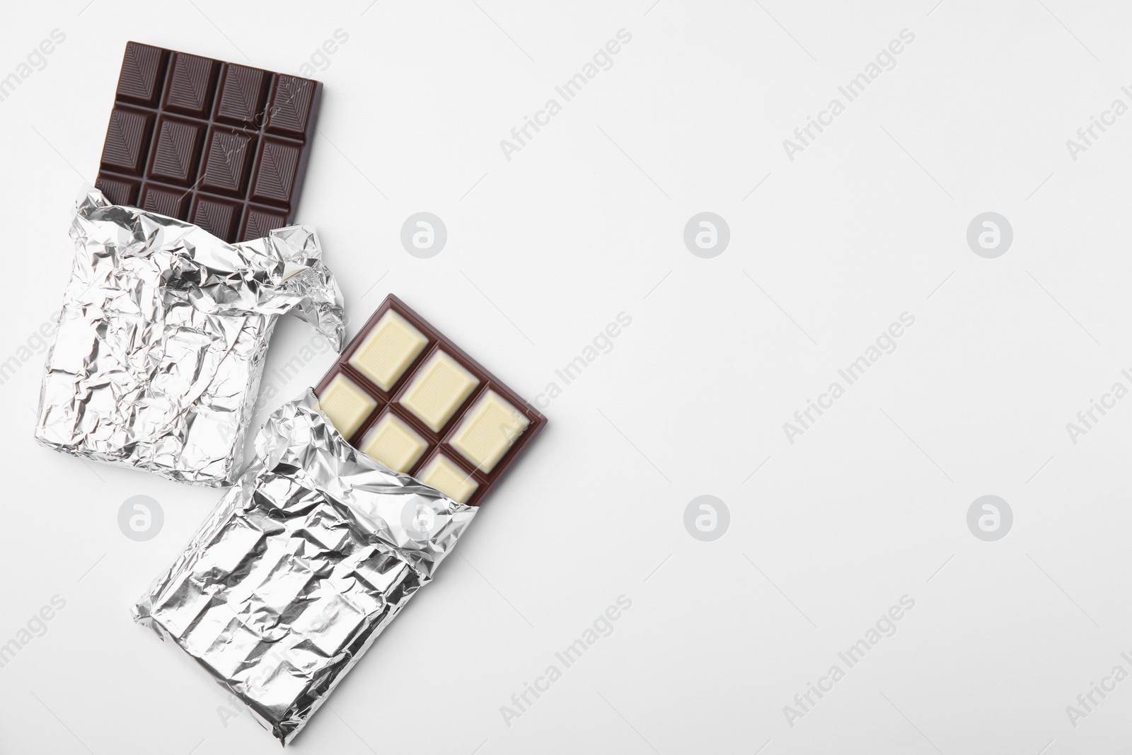 Photo of Tasty chocolate bars on white background, top view