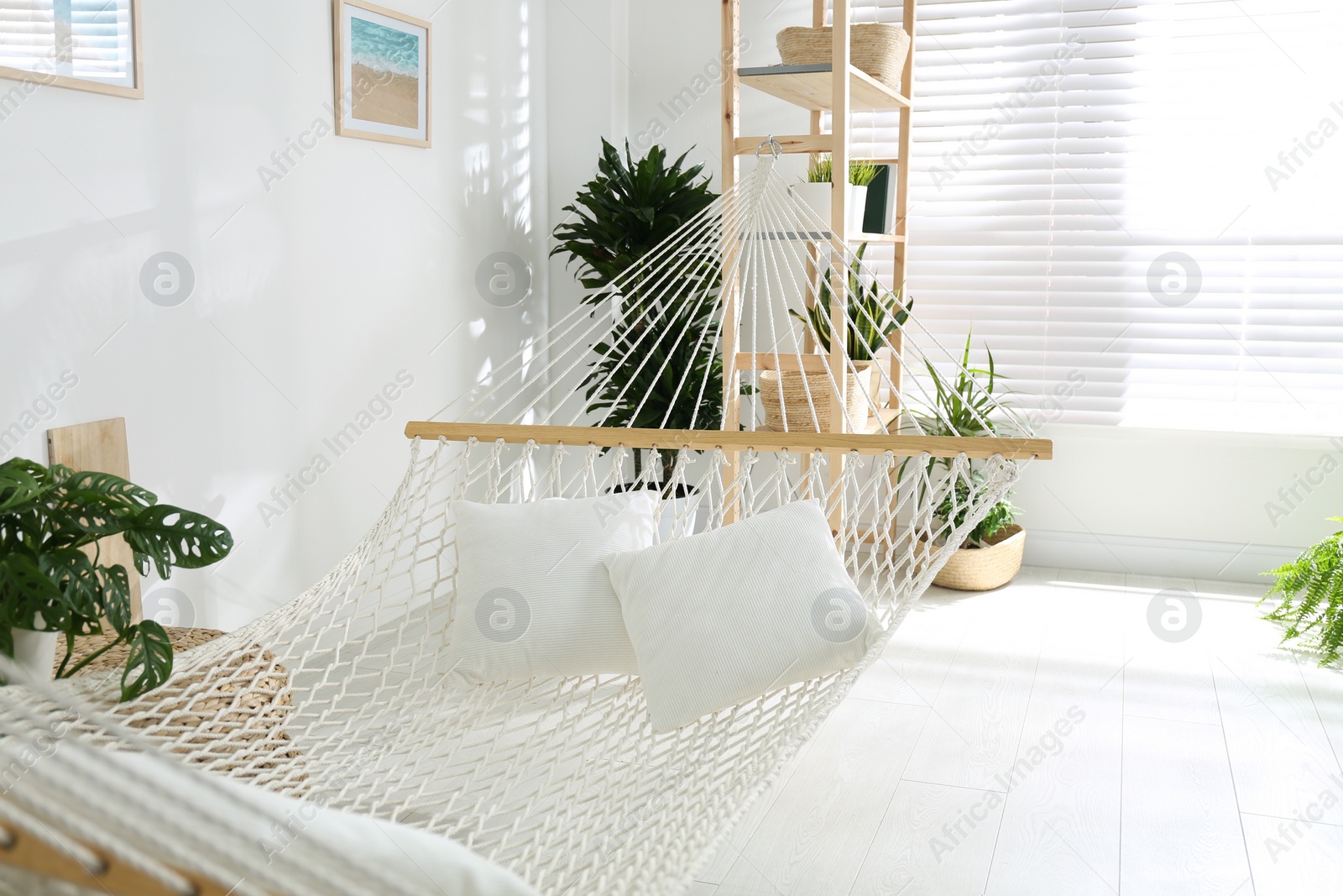 Photo of Comfortable hammock in stylish light room. Interior design