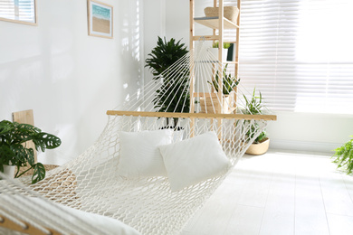 Comfortable hammock in stylish light room. Interior design