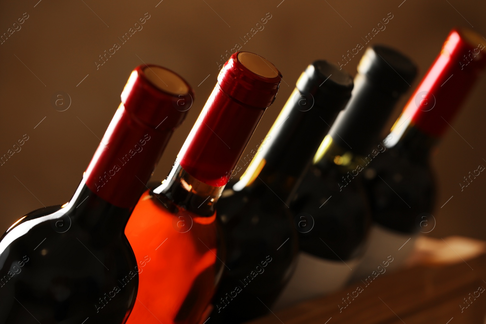 Photo of Bottles of different wines, closeup. Expensive collection