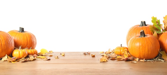 Composition with ripe pumpkins and autumn leaves on wooden table against white background. Happy Thanksgiving day