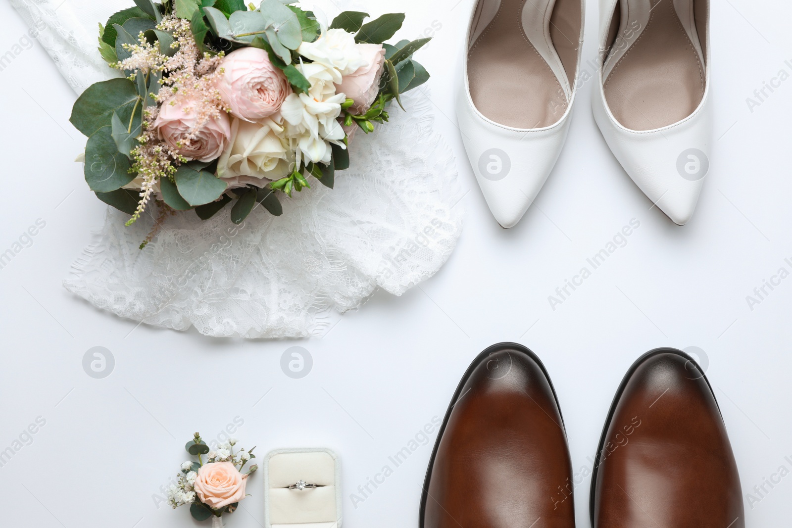 Photo of Composition with wedding shoes for bride and groom on white background, top view