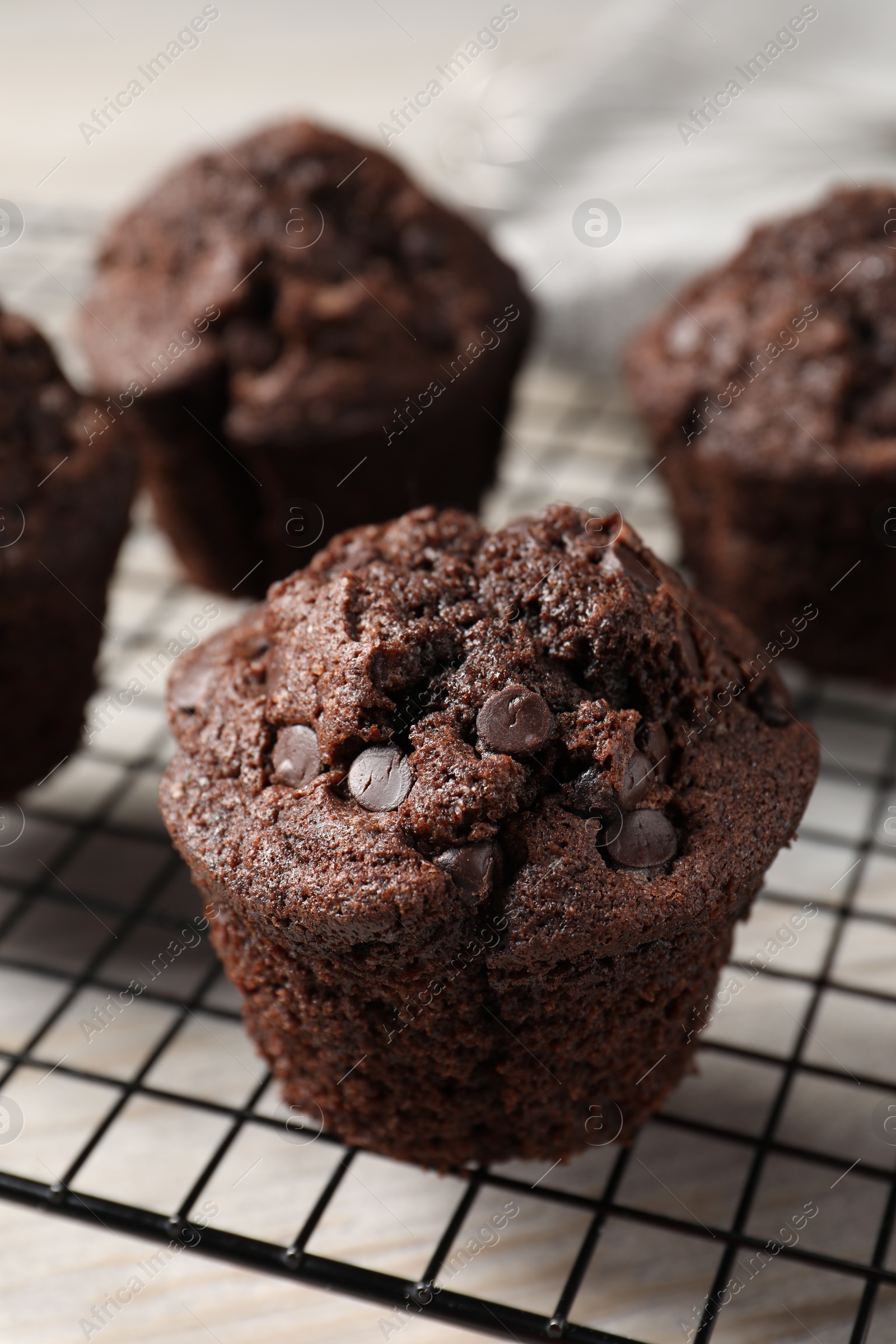 Photo of Delicious chocolate muffins on table, closeup view