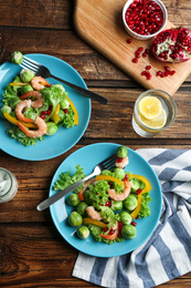 Photo of Tasty salad with Brussels sprouts served on wooden table, flat lay
