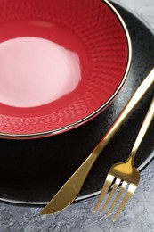 Photo of Clean plates, bowl and cutlery on table, closeup