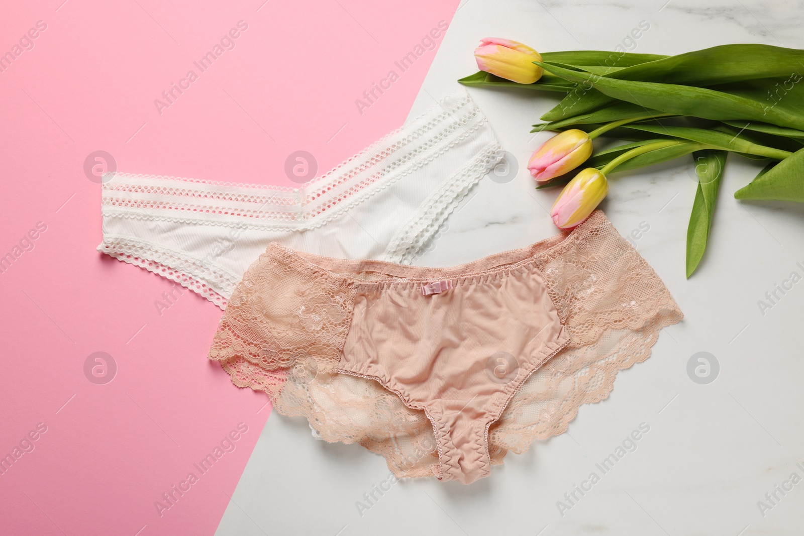 Photo of Elegant women's underwear and beautiful tulips on color background, flat lay