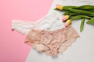 Photo of Elegant women's underwear and beautiful tulips on color background, flat lay