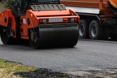 Photo of Modern roller on city street. Road repair service