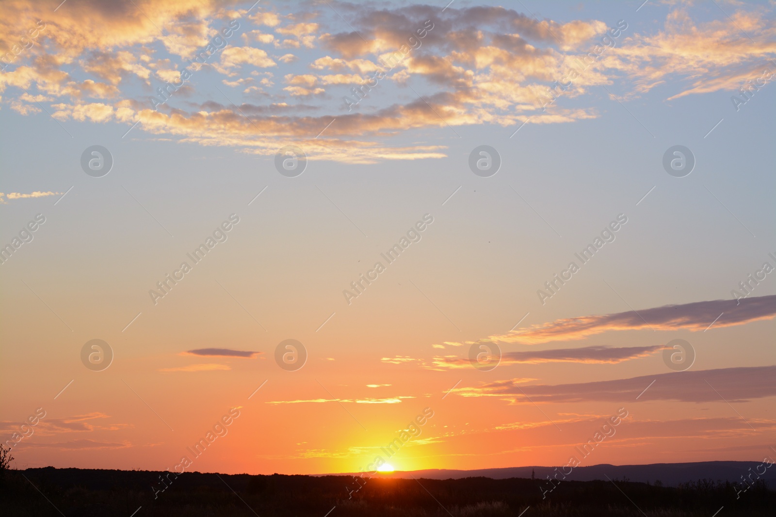 Photo of Picturesque view of landscape under beautiful evening sky with clouds at sunset