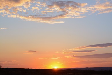 Picturesque view of landscape under beautiful evening sky with clouds at sunset