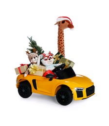 Child's electric car with toys, gift boxes and Christmas decor on white background