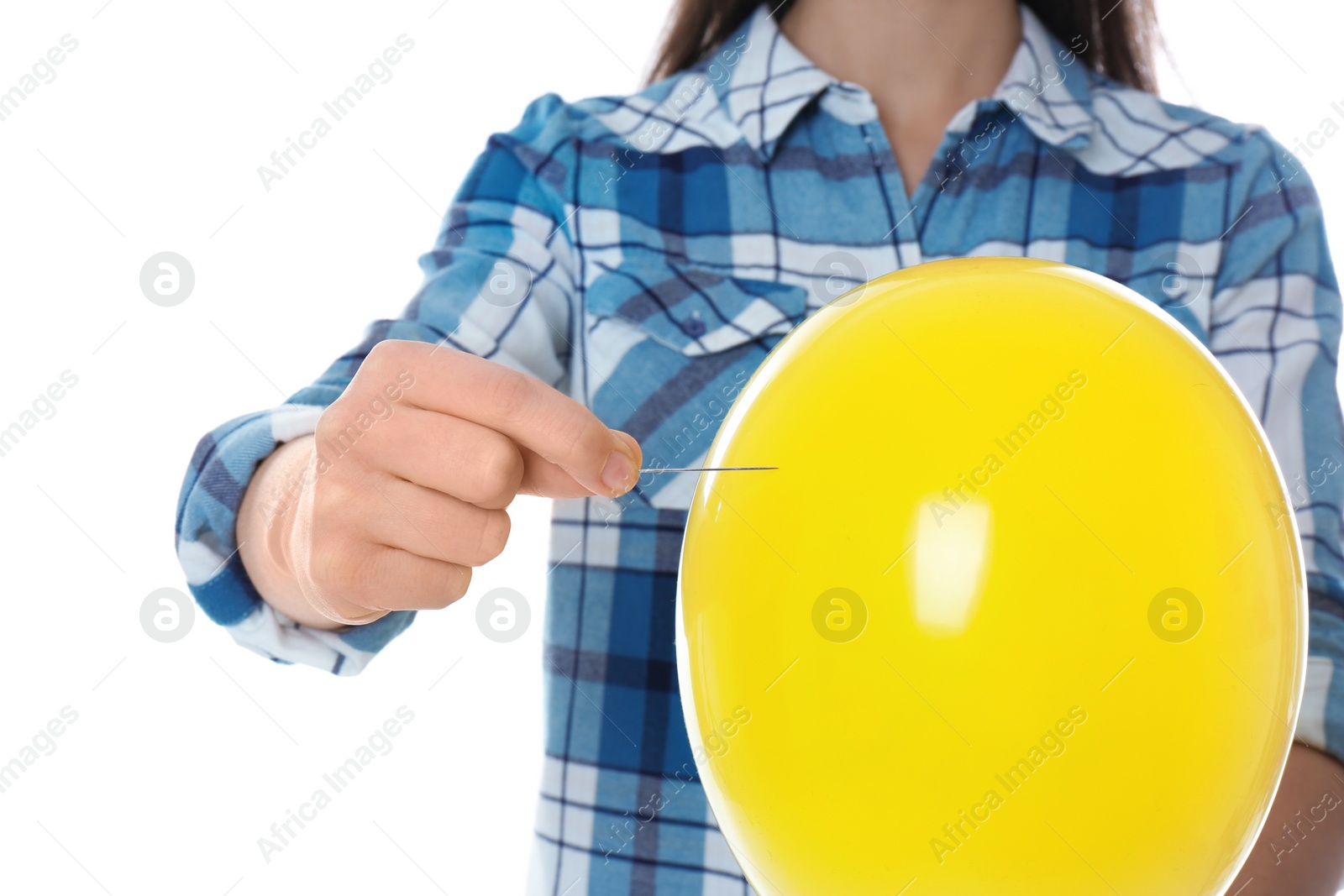 Photo of Woman piercing yellow balloon on white background, closeup