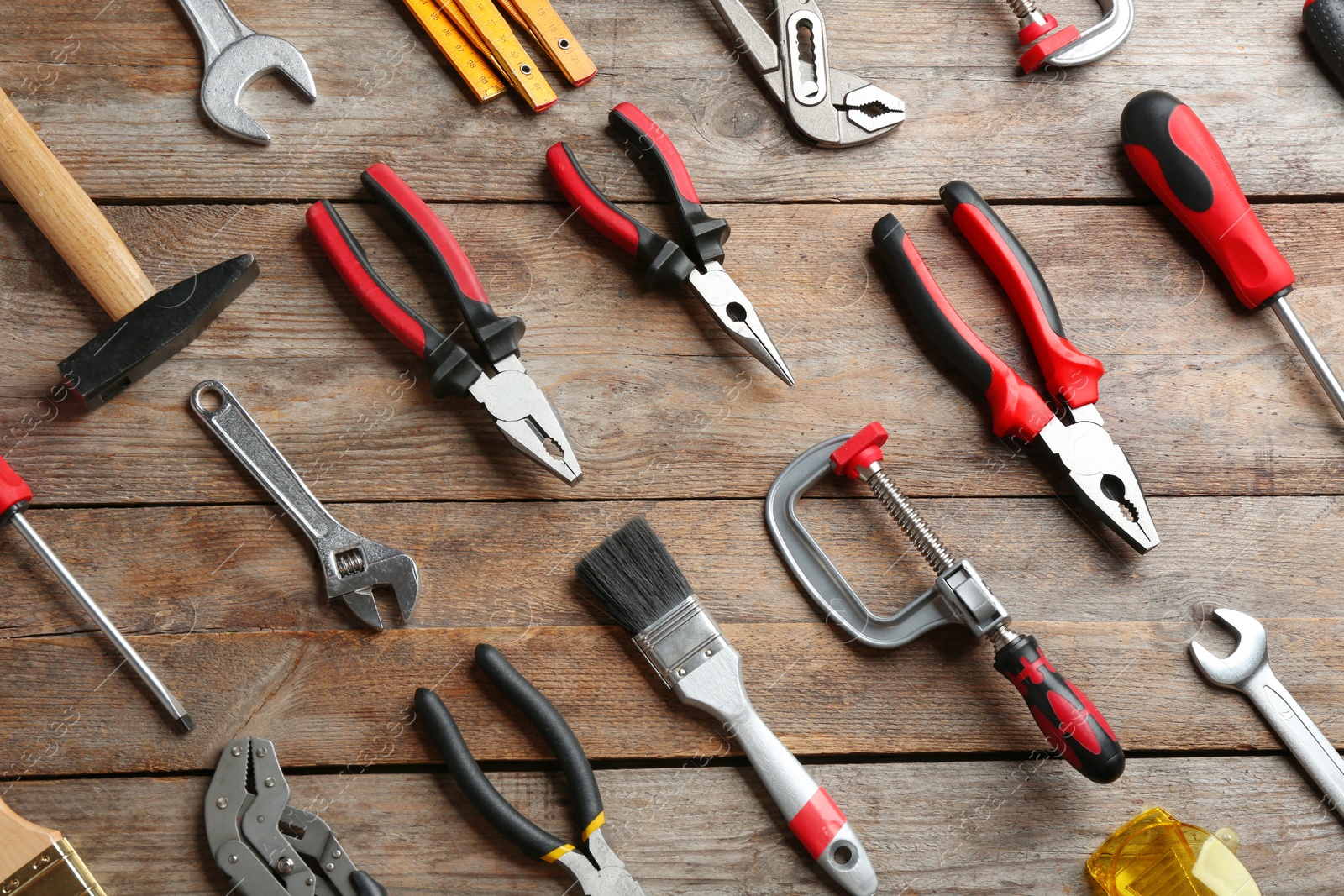 Photo of Flat lay composition with construction tools on wooden background