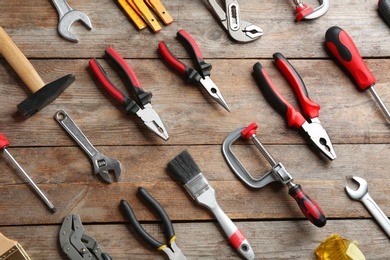 Photo of Flat lay composition with construction tools on wooden background